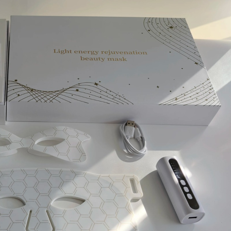 White Amporea LED mask packaging with gold foil detailing, USB cable and controller